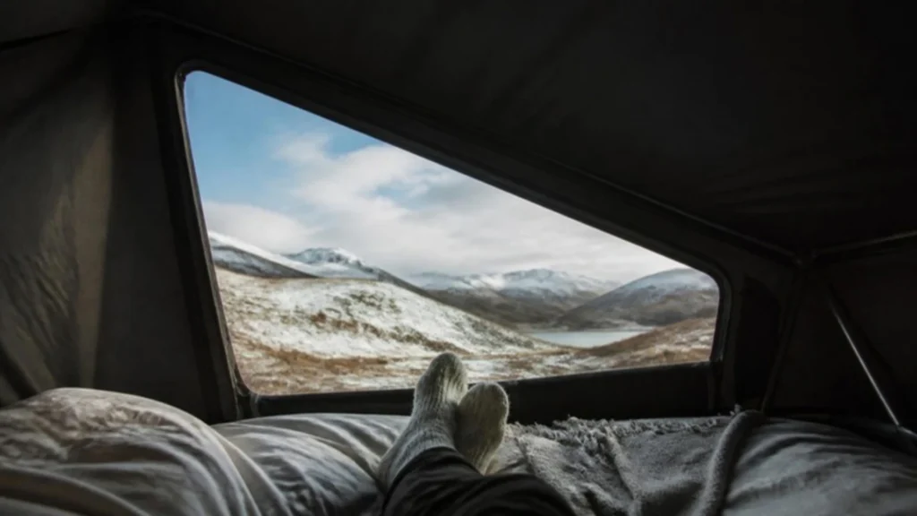 Pop top scenic canvas view from bed over snowy mountains